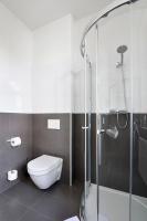 a bathroom with a toilet and a glass shower at Hotel Garden Court in Prague