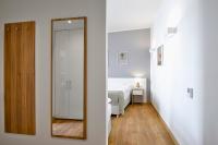 a mirror in a room with a bed and a bedroom at Hotel Garden Court in Prague