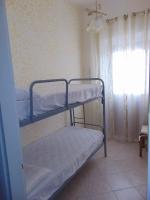A bed or beds in a room at Appartamenti Budoni