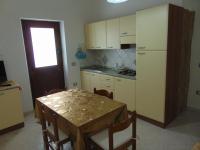 A kitchen or kitchenette at Appartamenti Budoni