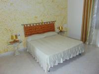 A bed or beds in a room at Appartamenti Budoni