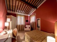 A bed or beds in a room at Albergo La Foresteria