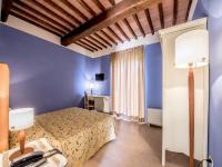 A bed or beds in a room at Albergo La Foresteria