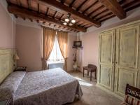 A bed or beds in a room at Albergo La Foresteria