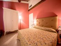 A bed or beds in a room at Albergo La Foresteria