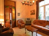 a living room with leather furniture and a tv at This plain house is very suitable for groups in Ferrières