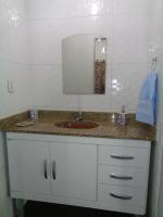 a bathroom counter with a sink and a mirror at Casa com Piscina Paraty in Paraty