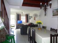 a living room with a table and a couch at Casa com Piscina Paraty in Paraty