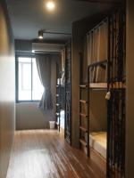 a room with two bunk beds and a window at Silom Space Hostel in Bangkok