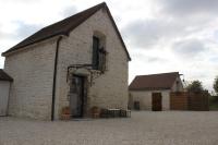 a large brick building with a balcony on the side at Charmante Maison Pierres 1768 in Polisy