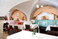 a dining room with white tables and chairs at Hotel Alt-Oberndorf in Oberndorf bei Salzburg