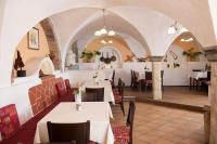 a restaurant with white tables and chairs in a room at Hotel Alt-Oberndorf in Oberndorf bei Salzburg