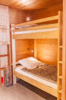 a room with two bunk beds in a cabin at Studio Beauregard in Le Grand-Bornand