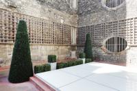 a courtyard with trees and a white table at Terrace Matignon Apartment in Paris