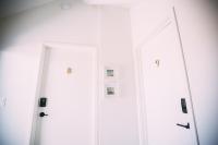 two doors in a white room with pictures on them at Noon on Sunset Hill in Los Angeles