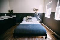 a bedroom with a bed with a blue and white blanket at Noon on Sunset Hill in Los Angeles