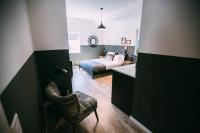a bedroom with a bed and a chair in a room at Noon on Sunset Hill in Los Angeles