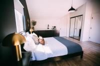 a bedroom with a white bed and a lamp at Noon on Sunset Hill in Los Angeles