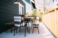 a patio with tables and chairs on the side of a house at Noon on Sunset Hill in Los Angeles