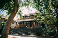 a house with a balcony and stairs in front of it at Noon on Sunset Hill in Los Angeles