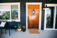 a wooden door on a house with a table and chairs at Noon on Sunset Hill in Los Angeles