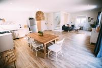 a kitchen and living room with a wooden table and chairs at Noon on Sunset Hill in Los Angeles