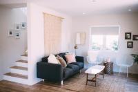 a living room with a blue couch and a window at Noon on Sunset Hill in Los Angeles