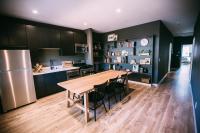 a kitchen and dining room with a wooden table and chairs at Noon on Sunset Hill in Los Angeles
