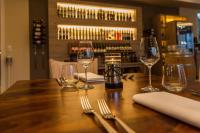 a wooden table with wine glasses and utensils on it at Parkhotel Cochem in Cochem