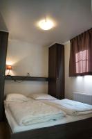 a large bed in a room with a window at Camping Bissen in Esch-sur-Sûre