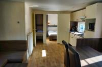 a small apartment with a kitchen and a dining room at Camping Bissen in Esch-sur-Sûre