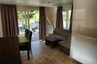 a living room with a desk and a room with a window at Camping Bissen in Esch-sur-Sûre