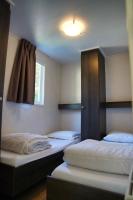 a room with two beds and a window at Camping Bissen in Esch-sur-Sûre