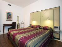 A bed or beds in a room at Hotel Buonconsiglio