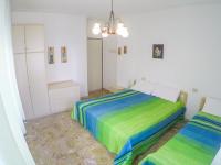 a bedroom with two beds in a room at Condominio Sole - Agenzia Cocal in Caorle