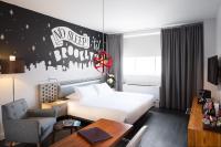 a hotel room with a bed and a desk at NU Hotel in Brooklyn