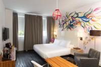 a hotel room with a bed and a chair at NU Hotel in Brooklyn