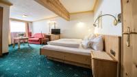 A bed or beds in a room at Hotel Kristall