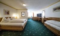 A bed or beds in a room at Hotel Kristall