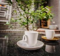 two coffee cups sitting on a table with a plate at Dot Minsu in Wujie