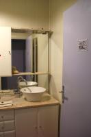 a bathroom with a sink and a mirror at La Maison des Chats in Saint-Mary-le-Plain