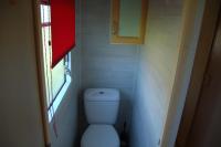 a small bathroom with a toilet and a window at Lac de la Vie in Bressuire