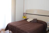 Łóżko lub łóżka w pokoju w obiekcie Hotel Allo Zodiaco