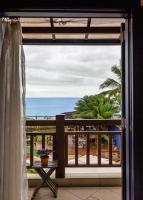 a room with a view of the ocean from a balcony at Pousada DiMari in Boicucanga