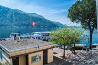 a view of a marina with a boat in the water at Al Battello in Morcote