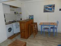 a kitchen with a table and a table and chairs at Appartement vue sur le port de Dieppe in Dieppe