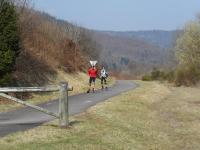 two people are running on a road at Chalet de Grettery in Saulxures-sur-Moselotte