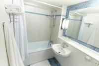 Un baño con bañera, lavabo e inodoro. en Campanile Saint-Avold, en Saint-Avold