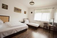 A bed or beds in a room at Döre Vendégház