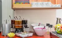 a kitchen counter with a mixer and some food at Hotel Garden Court in Prague